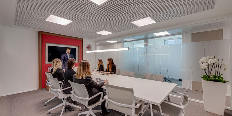 Employees sat round a large table in a Regus meeting room